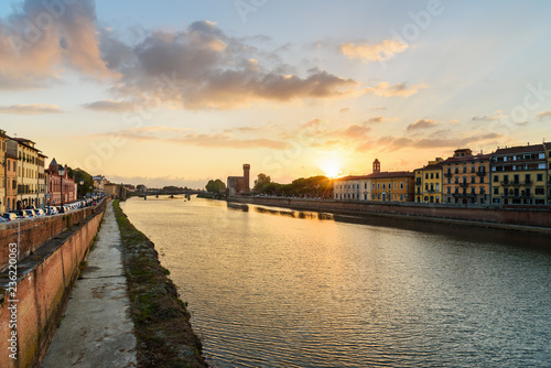 View on embankment of Arno river at sunset. Pisa, Italy