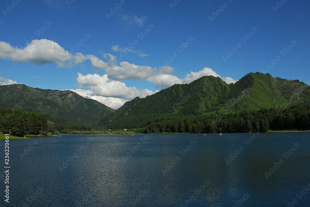 Lake surrounded by wooded hills.