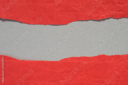 red torn paper with copy space on gray background