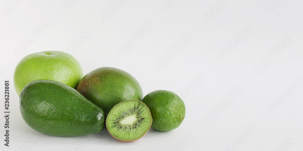 Creative background of green various summer tropical fruits. Food concept for fitness dinner,plant based diet,frutarian,healthy eating Creative background of green various summer tropical fruits. Food concept for fitness dinner,plant based diet,frutarian,healthy eating