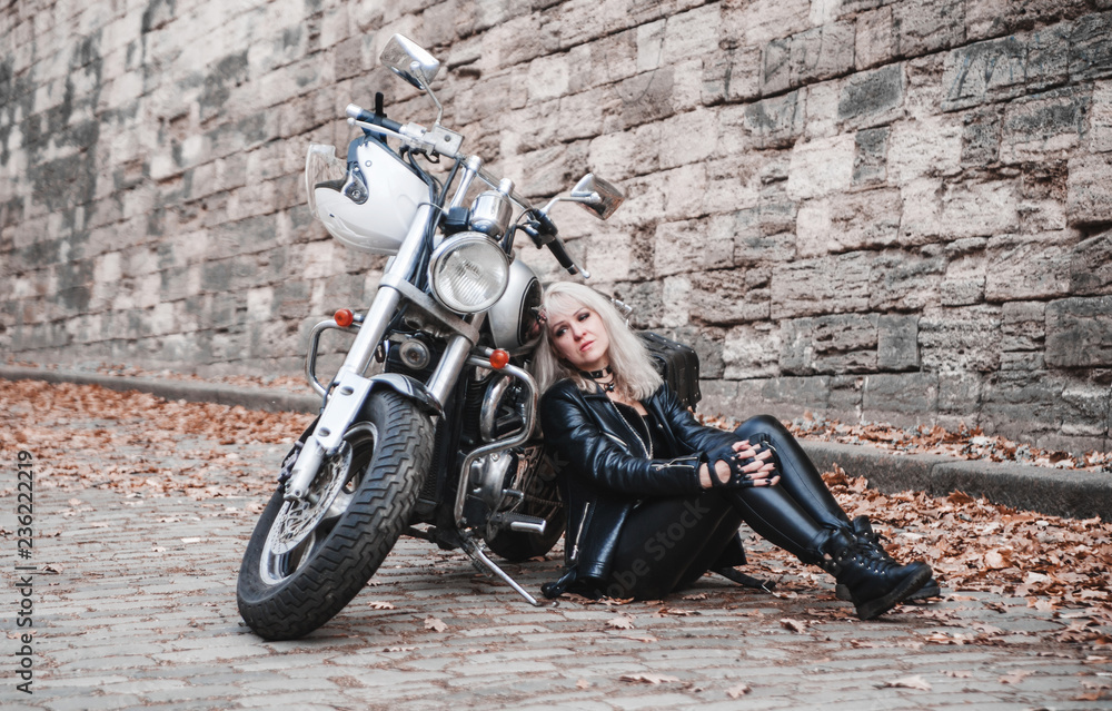 Beautiful woman with motorcycle outdoor.
Beautiful woman with motorcycle outdoor.