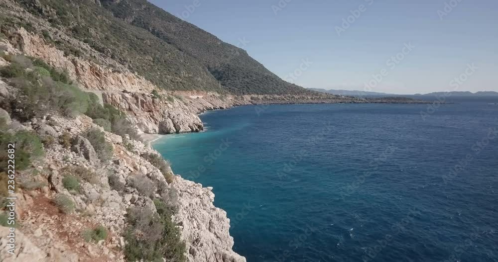 Forward aerial drone video along cliffs above turquoise Mediterranean Sea water reveal sandy Kaputas Beach cove near Kas, Turkey. 4k at 23.97fps Forward aerial drone video along cliffs above turquoise Mediterranean Sea water reveal sandy Kaputas Beach cove near Kas, Turkey. 4k at 23.97fps