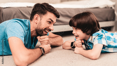Father and Son Lying on Floor and Have Fun at Home