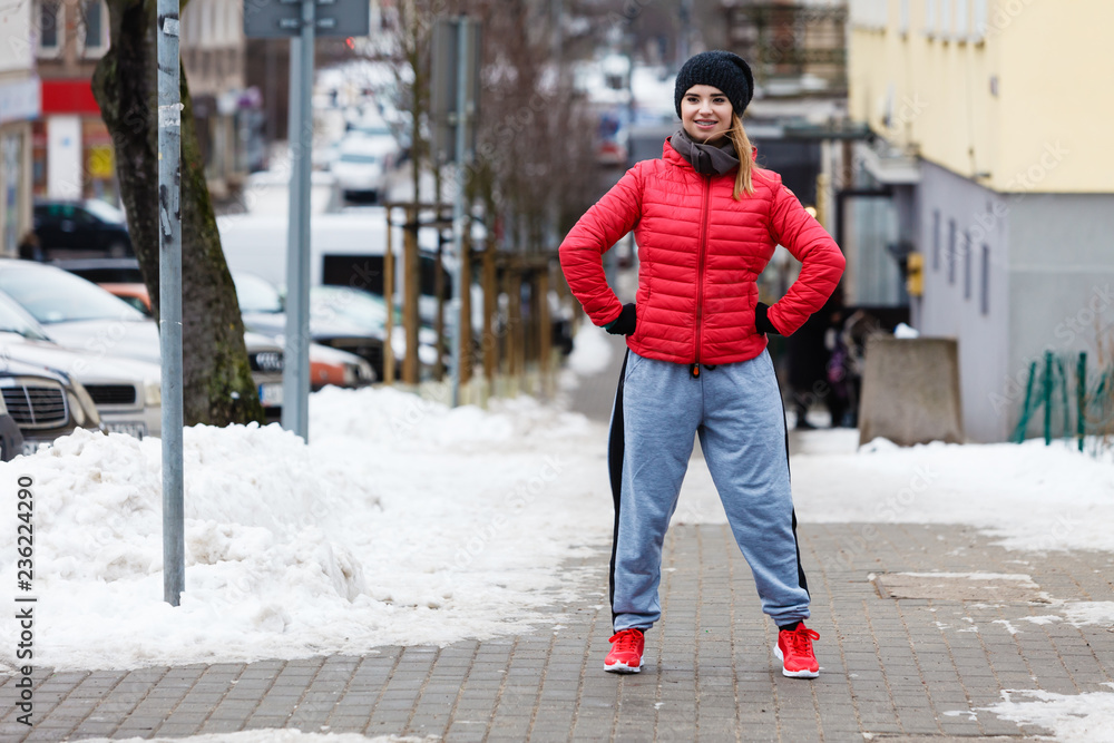 Fototapeta premium Woman wearing sportswear exercising outside during winter