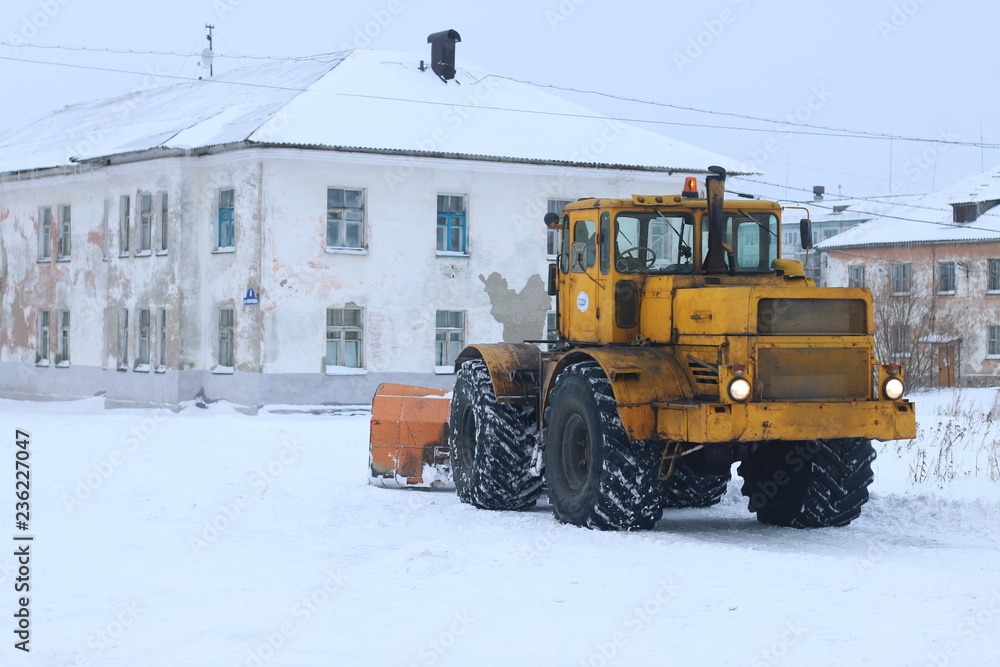 snowplow clearing roads of snow. tractor remove snow from city