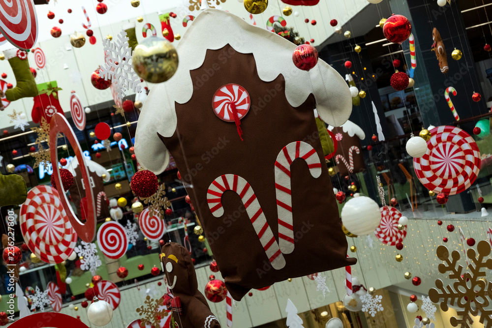 Obraz premium Festive decor of the house among other Christmas decorations. Abstract background of New Year's decoration in the store, airport or station room.