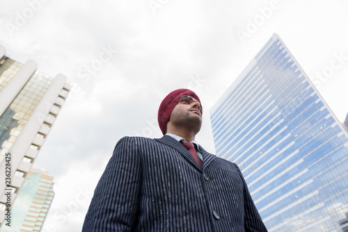 Portrait of Indian businessman with turban outdoors in city photo