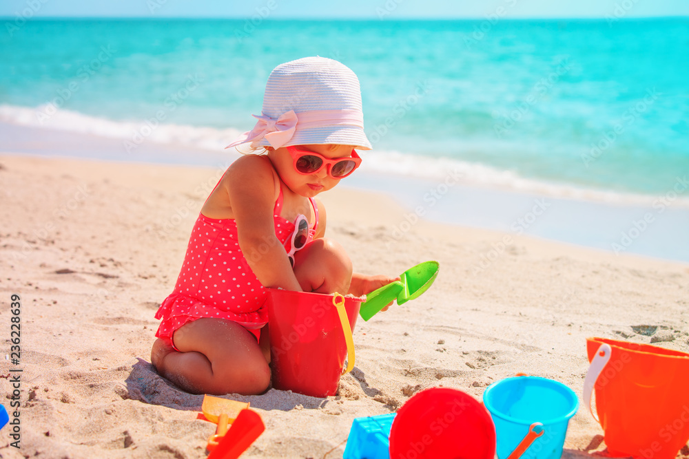 cute little girl play with sand on beach cute little girl play with sand on beach