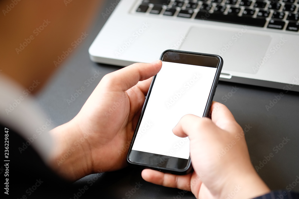 Cropped shot businessman in suit using mockup smartphone. Cropped shot businessman in suit using mockup smartphone.