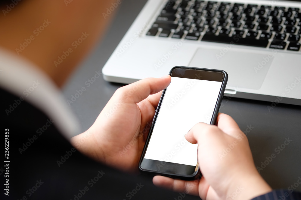 Cropped shot businessman in suit using mockup smartphone.