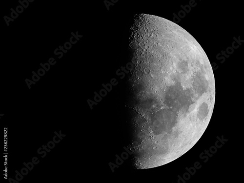 Half moon / The Moon is an astronomical body that orbits planet Earth and is Earth's only permanent natural satellite. It is the fifth-largest natural satellite in the Solar System