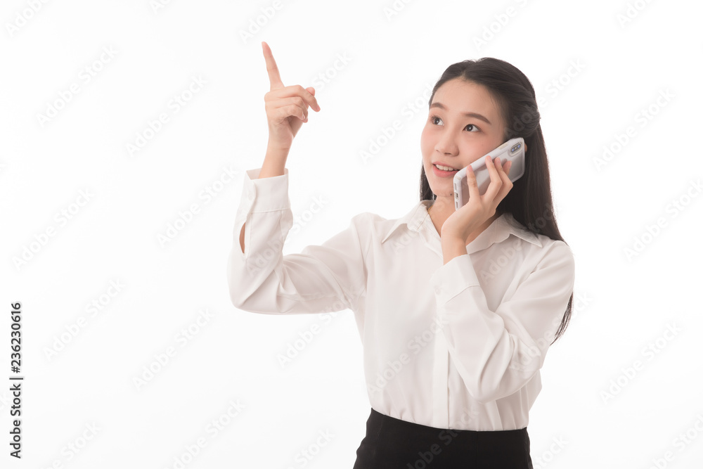 Portrait of asian business woman on phone call on white background in studio. Woman holding smartphone and point up. Portrait of asian business woman on phone call on white background in studio. Woman holding smartphone and point up.