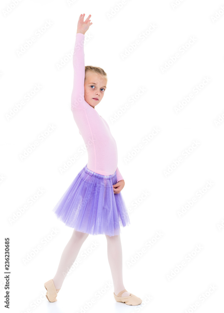 Little girl ballerina performs dance.