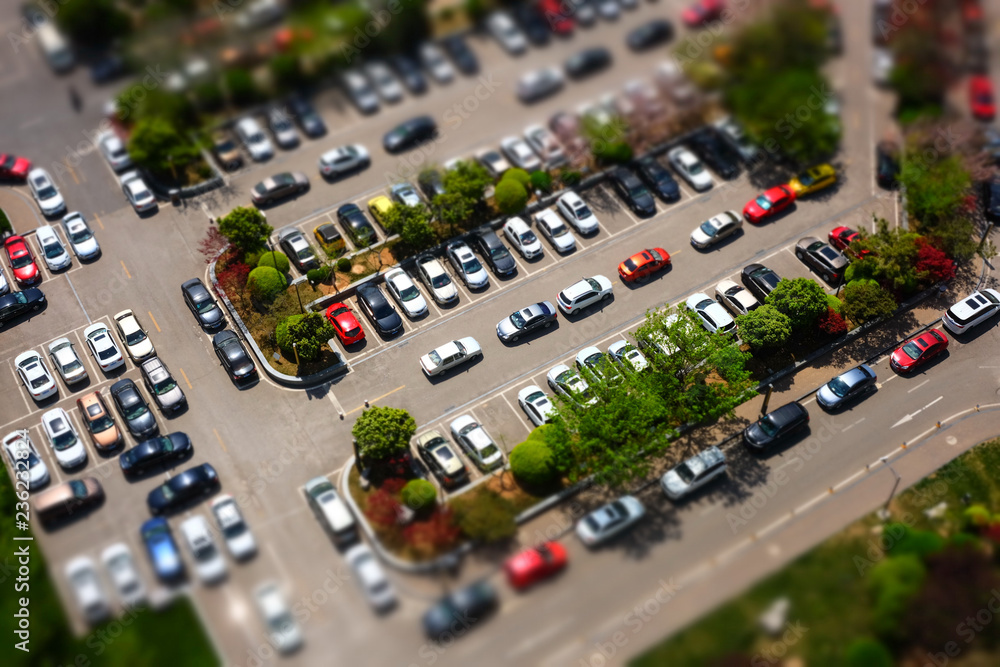 dense parking lot in tilt shift effect in top view
