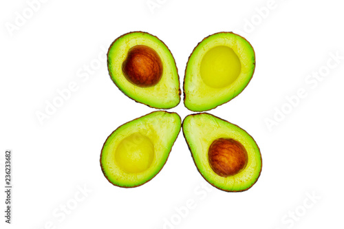 Avocado with seed isolated on white background. Source of omega 3 from natural food. Healthy food for baby. Half pieces of avocados arranged with beautiful flower pattern. Organic food for vegetarian. photo