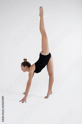 Beautiful young woman limber exerciser in the studio