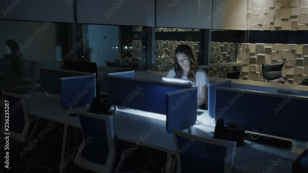 Young Business Woman Working Overtime In Office At Night Young Business Woman Working Overtime In Office At Night