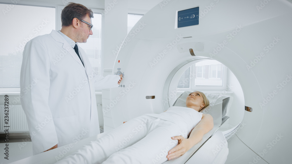 In Medical Laboratory Radiologist Controls MRI or CT or PET Scan with Female Patient Undergoing Procedure. Professional Doctor Conducts Emergency Checkup Procedure with Advanced Medical Technologies. In Medical Laboratory Radiologist Controls MRI or CT or PET Scan with Female Patient Undergoing Procedure. Professional Doctor Conducts Emergency Checkup Procedure with Advanced Medical Technologies.