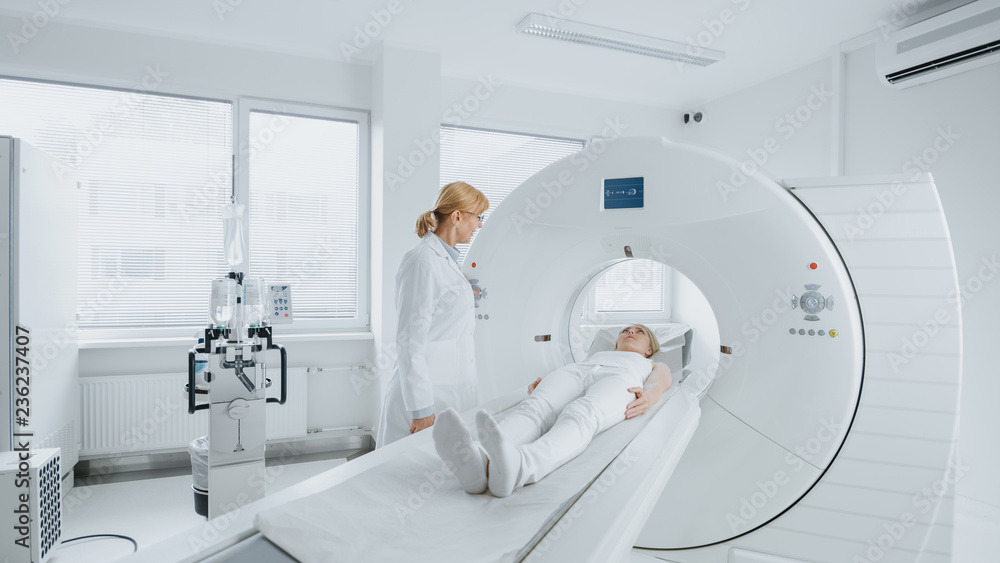 © Gorodenkoff - In Medical Laboratory Female Radiologist Controls MRI or CT Scan with Female Patient Undergoing Procedure. High-Tech Modern Medical Equipment. © Gorodenkoff - In Medical Laboratory Female Radiologist Controls MRI or CT Scan with Female Patient Undergoing Procedure. High-Tech Modern Medical Equipment.