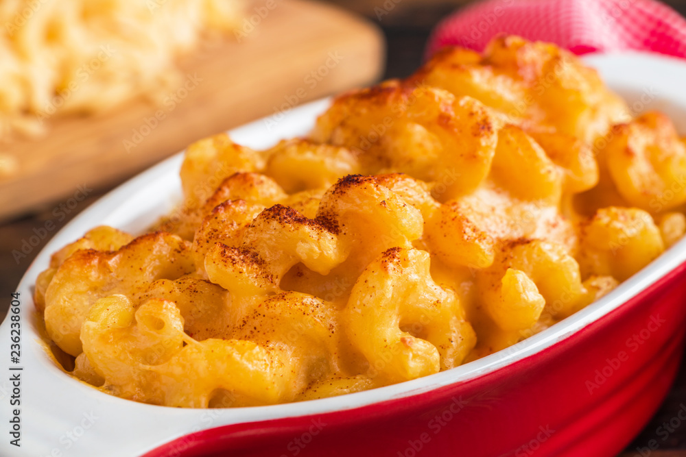 Mac and Cheese, American pasta in red casserole, closeup. Mac and Cheese, American pasta in red casserole, closeup.