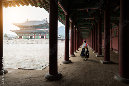 Photography Asian Korean woman dressed Hanbok in traditional dress walking in Gyeongbokgung Palace in Seoul, South Korea