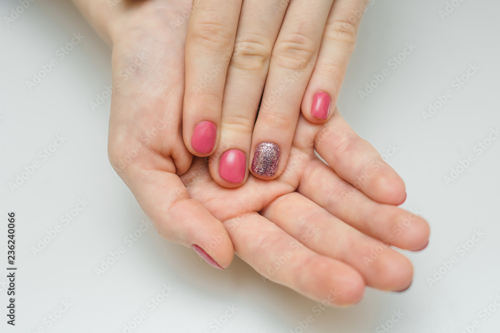 Hands with long artificial manicured nails colored with red nail polish Hands with long artificial manicured nails colored with red nail polish