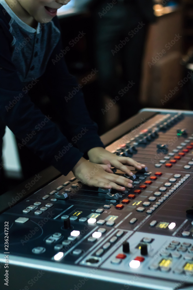 Little boy adjusting sound on DJ mixing panel. Little boy adjusting sound on DJ mixing panel.