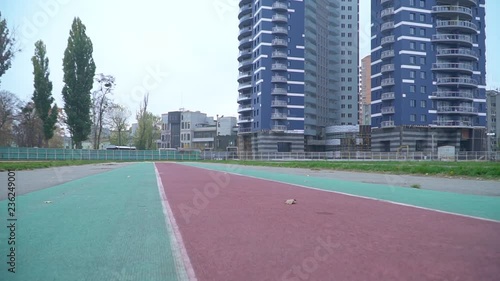 Wallpaper Mural Young man in sportswear quickly runs to the camera outdoors Sports guy running around the stadium Healthy lifestyle Torontodigital.ca