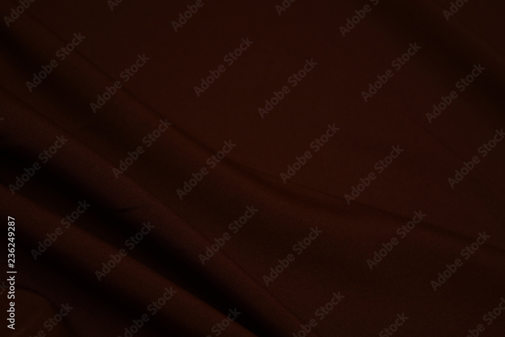 Texture of dark brown fabric closeup. Low key photo. Plexus threads. Clothing industry. Abstract background. Textile waves. Texture of dark brown fabric closeup. Low key photo. Plexus threads. Clothing industry. Abstract background. Textile waves.