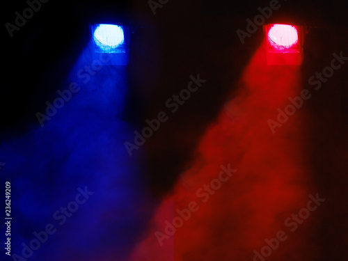 Theatrical light. Blue and red spotlights. A ray of light in the dark. Above the stage. Place for text.