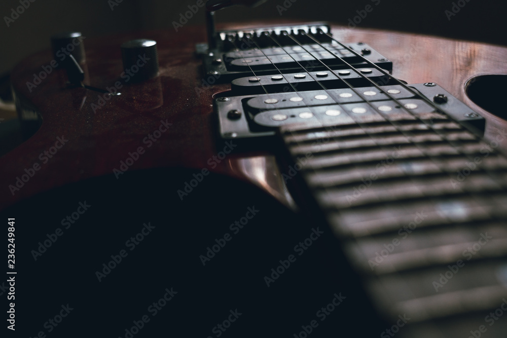 red electric guitar strings isolated on black background, closeup