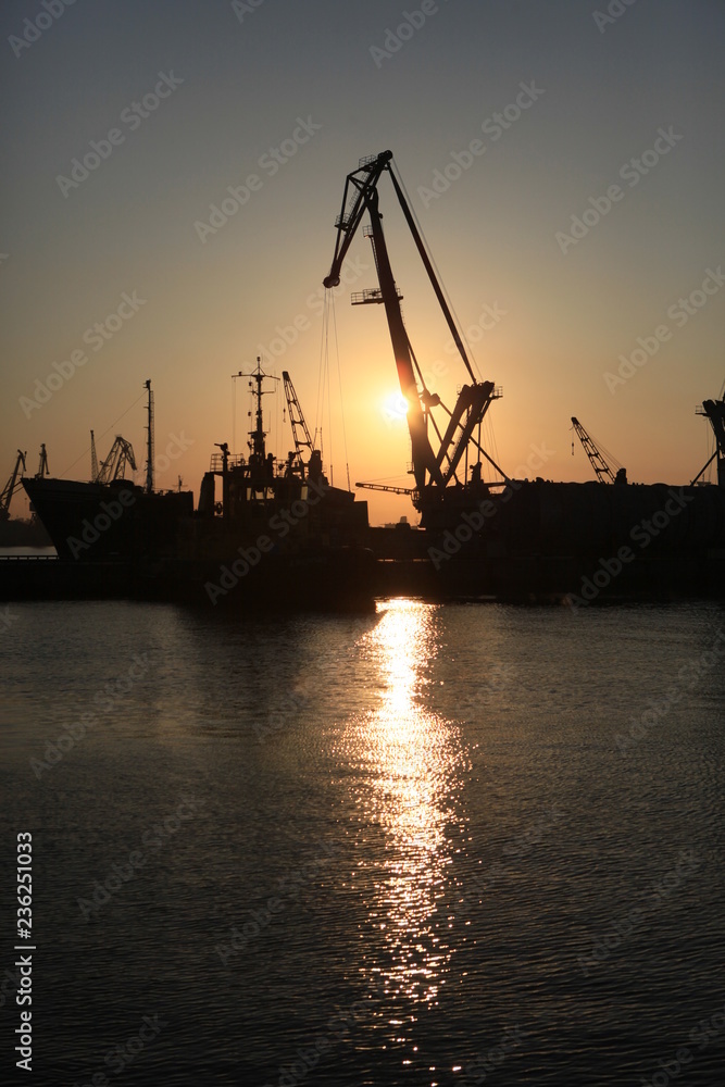 Sea ​​port cranes at sunset