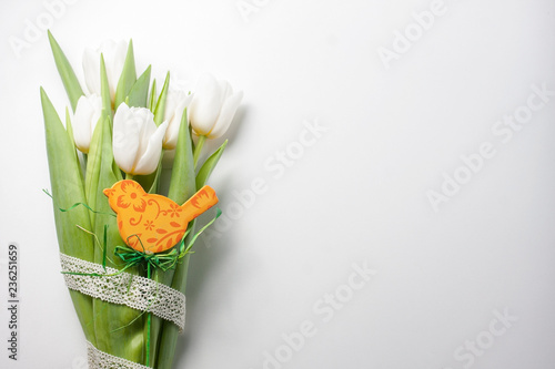 Easter arrangement  of a white tulips and wooden bird photo