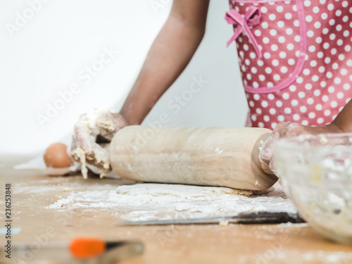 Girl hands rolling dough for making bread or pizza, lifestyle concept.