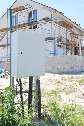 Electrical box. Electrical switchboard internal metal control box near house construction site outdoor.