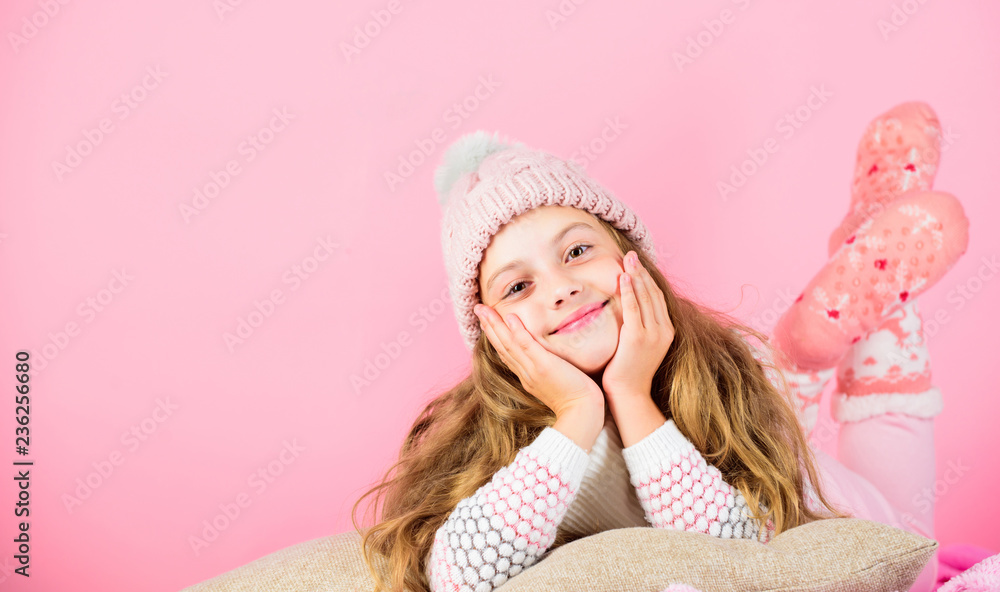Kid girl wear cute knitted fashionable hat and scarf accessory. Winter accessory concept. Girl long hair dream pink background. Kid dreamy face wear knitted accessory. Winter fashion accessory Kid girl wear cute knitted fashionable hat and scarf accessory. Winter accessory concept. Girl long hair dream pink background. Kid dreamy face wear knitted accessory. Winter fashion accessory