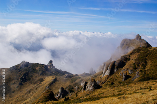 Landscape from Ciucas Peak in the Carpathian Mountains, Romania, with amazing shaped rocks, when fog is clearing on an autumn morning.