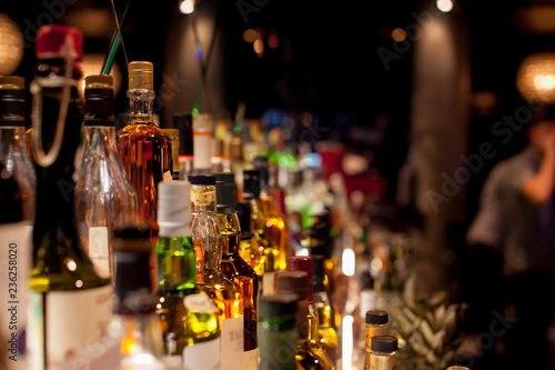 Fototapeta Bottles of spirits and liquor at the bar