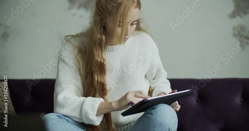 Young woman using notebook laptop computer in home photo