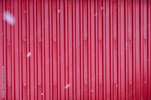 Red surface container warehouse lined with snowing