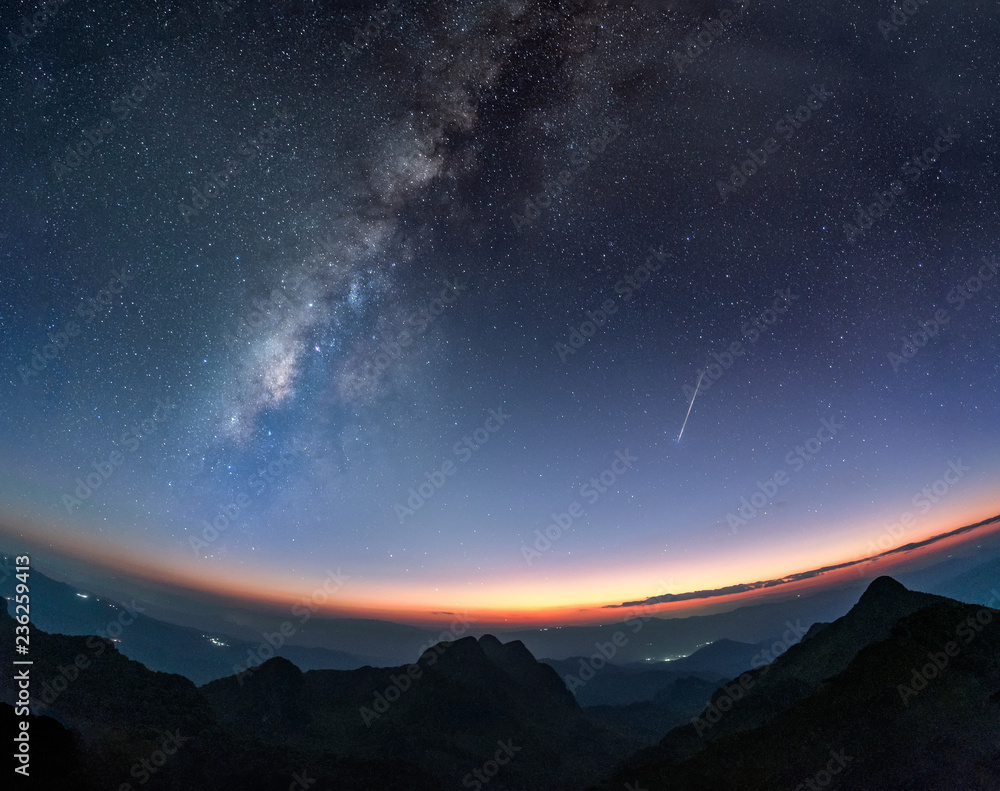 Naklejka premium Milky way galaxy with shooting star at twilight sunset