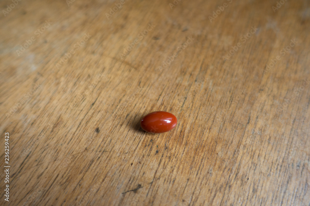 Pill of lutein dietary supplement on wood