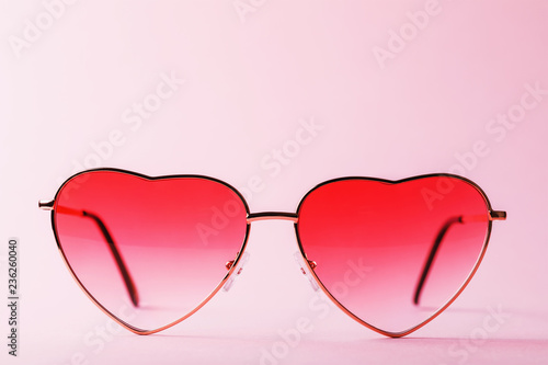 Womens sunglasses on a pink background close-up