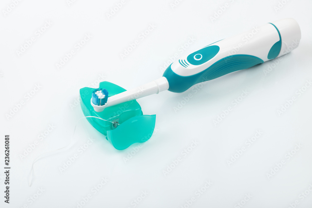 Dental floss with toothbrush on a white background. Dental floss with toothbrush on a white background.