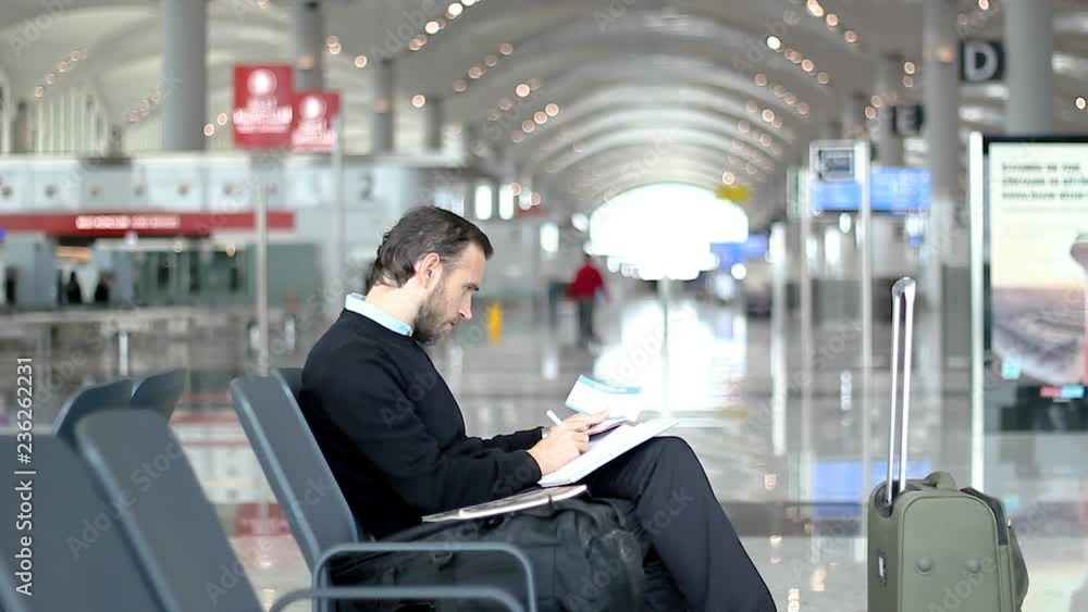 Man at the airport takes notes Man at the airport takes notes