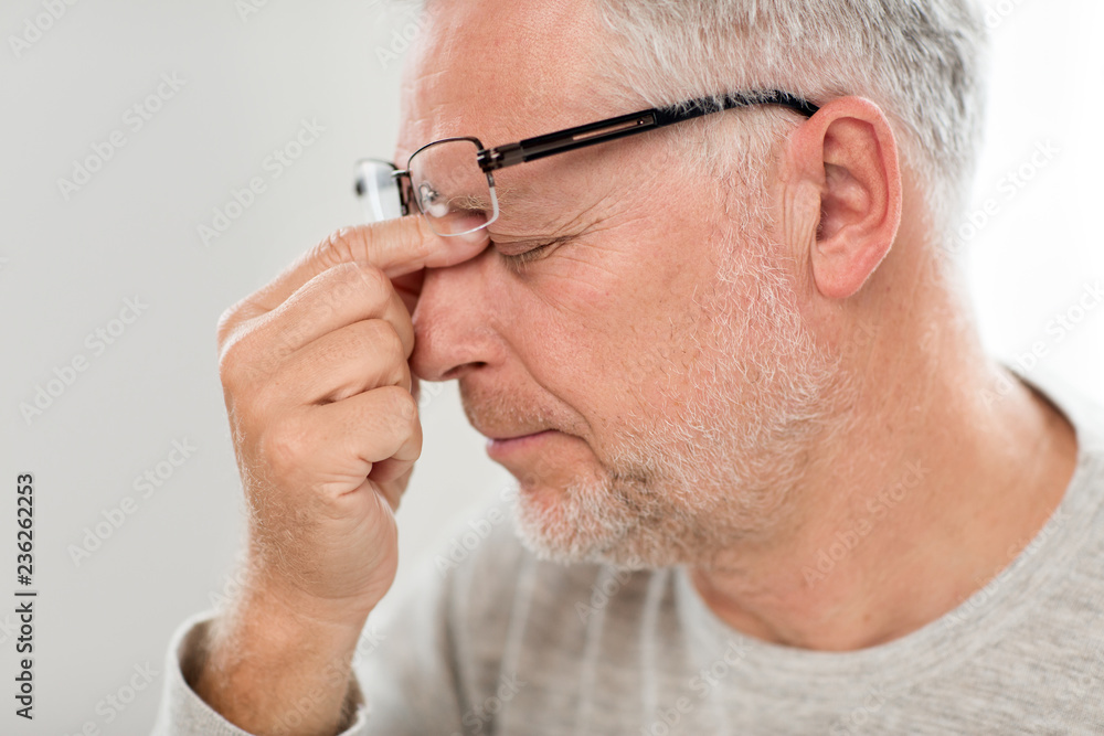 stress, old age and people concept - close up of senior man in glasses having headache and massaging nose bridge stress, old age and people concept - close up of senior man in glasses having headache and massaging nose bridge