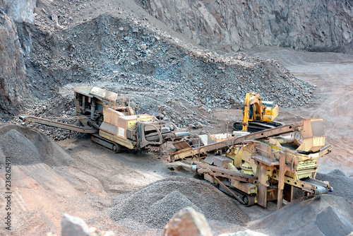 Canvas Print stone crusher in a quarry mine of porphyry rocks.