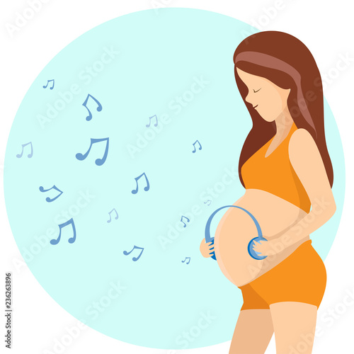 Pregnant woman hugging her belly and  listen the music