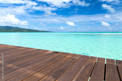 travel  seascape and nature concept - wooden pier on tropical beach in french polynesia