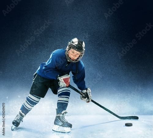 Photography Little boy playing ice hockey at arena